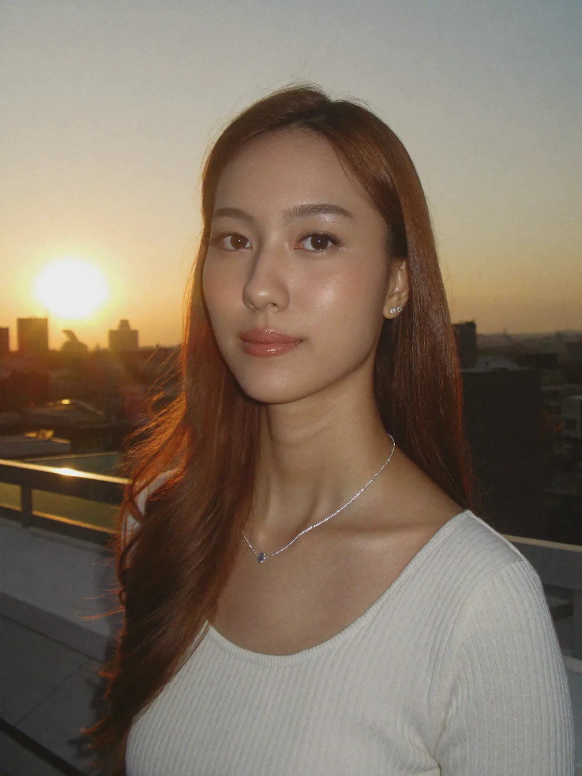 Golden hour rooftop, fine silver chain and stud