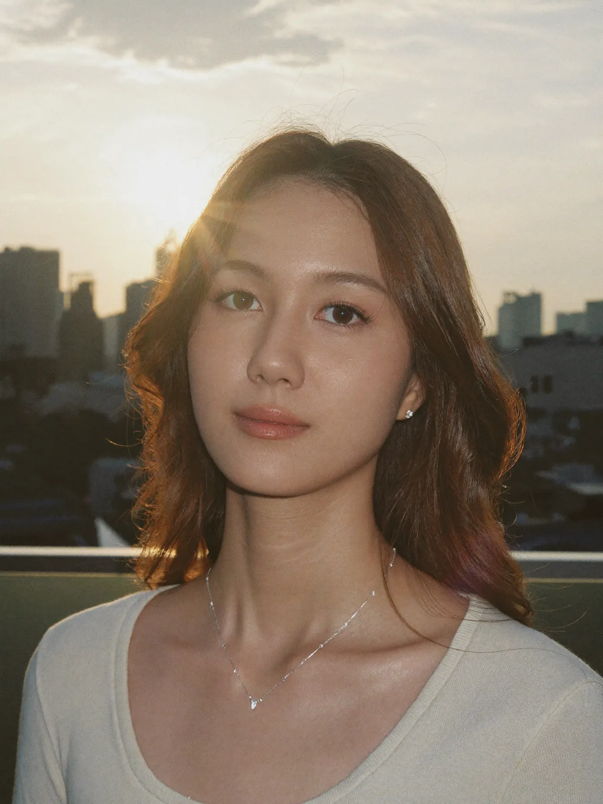 Backlit lens flare, a silver chain and pendant