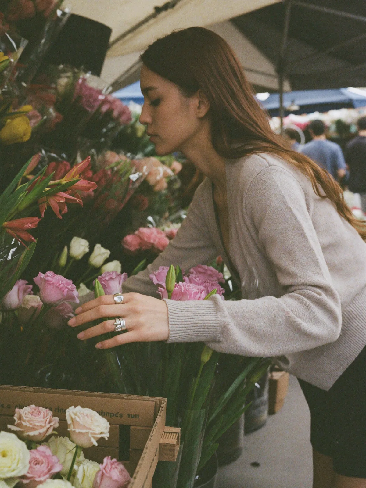 Tender moment at a flower market, two stacked silver rings