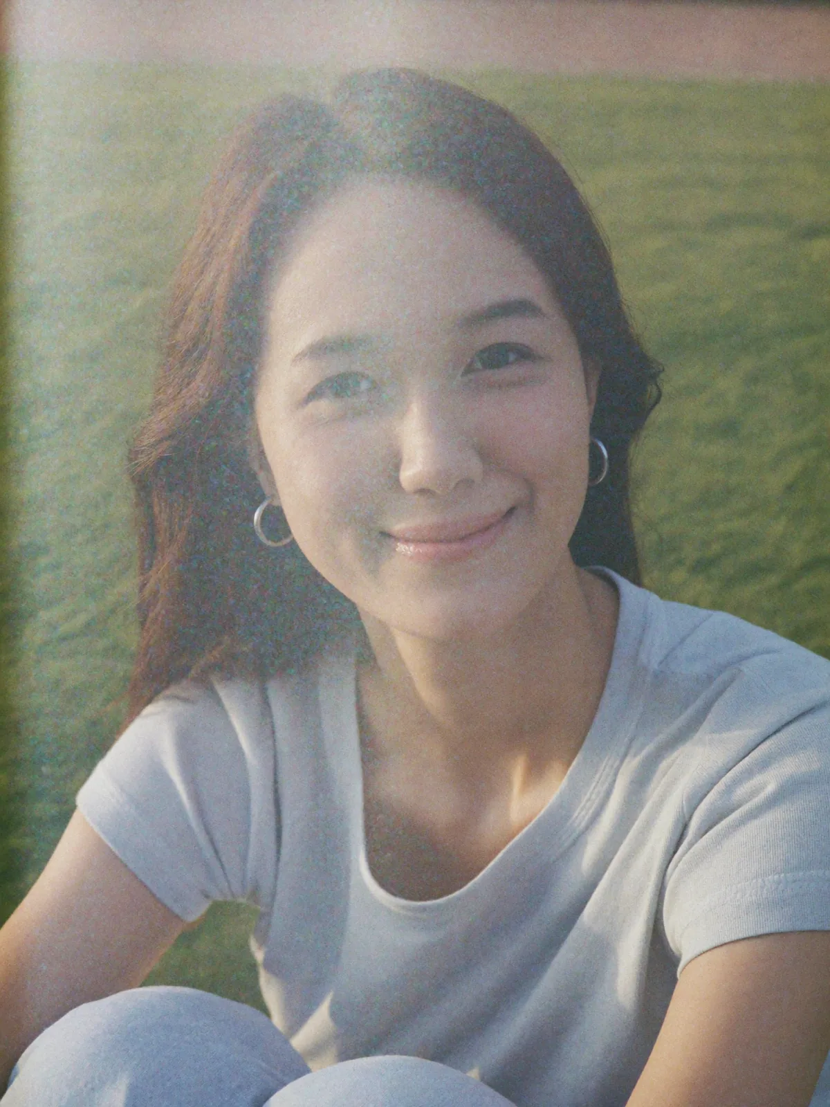 Sun-on-face bliss in the grass, a silver hoop